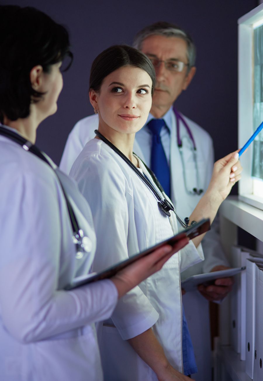 Clinicians reviewing training on a tablet in a hospital setting